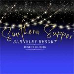 Two people smiling at the camera; the person on the left holds a star-shaped wand and wears a name badge.