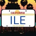 A California license plate displaying the letters "ILE" with palm trees and a sunset in the background.